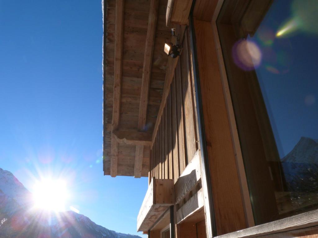 a building with the sun in the sky at La Cubelette in Chamonix
