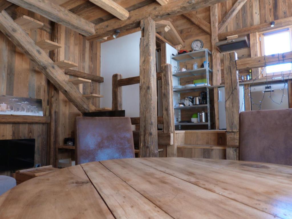 a dining room with a wooden table and chairs at La Cubelette in Chamonix