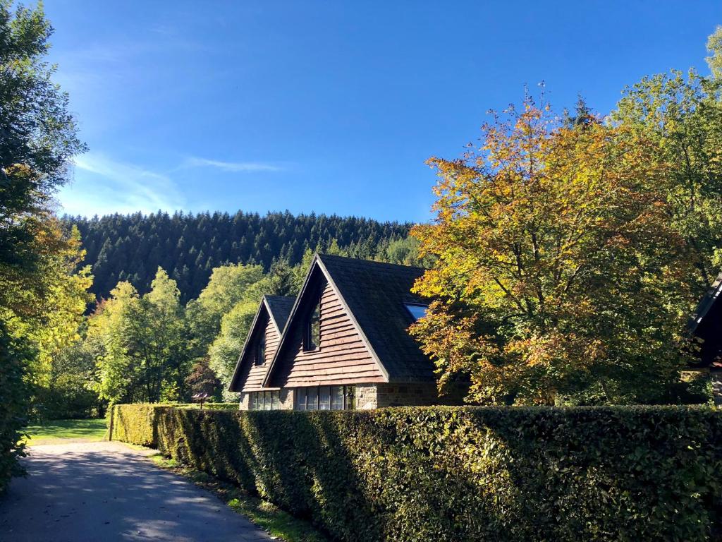 a house with a fence next to a road at Val d'Arimont Resort in Malmedy