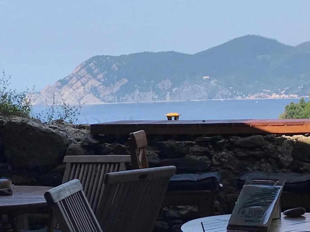 a table and chairs with a view of the water at il Magàn - Cinque Terre in Corniglia