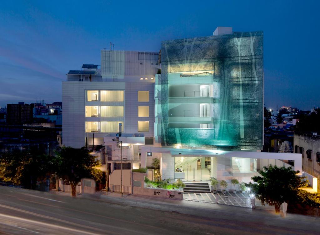 a building with a glass facade at night at Springs Hotels and Spa in Bangalore