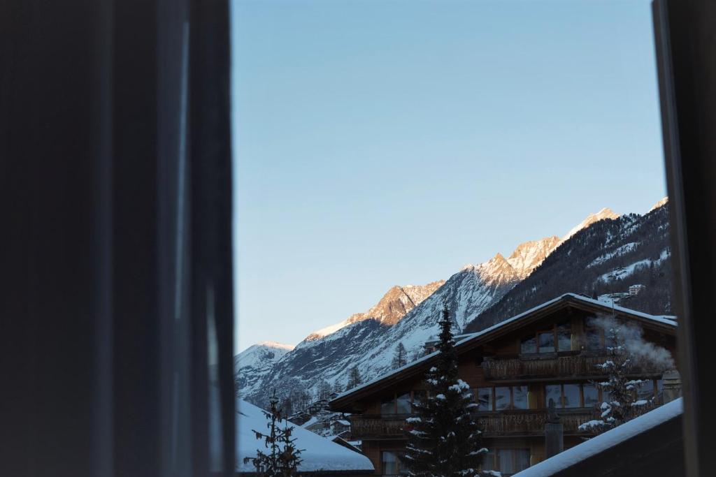 a view of a ski lodge from a window at Haus-Ascot-Zermatt in Zermatt