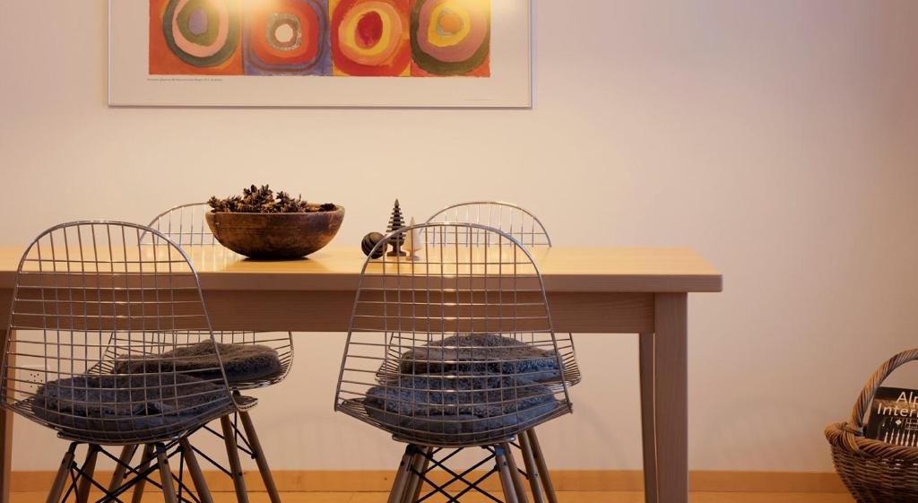a table with two chairs and a bowl on it at Haus-Ascot-Zermatt in Zermatt