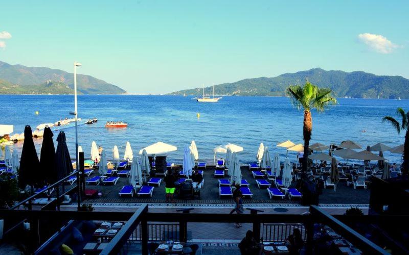 a group of chairs and umbrellas on a beach at LA BEIRUT BEACH HOTEL in Marmaris