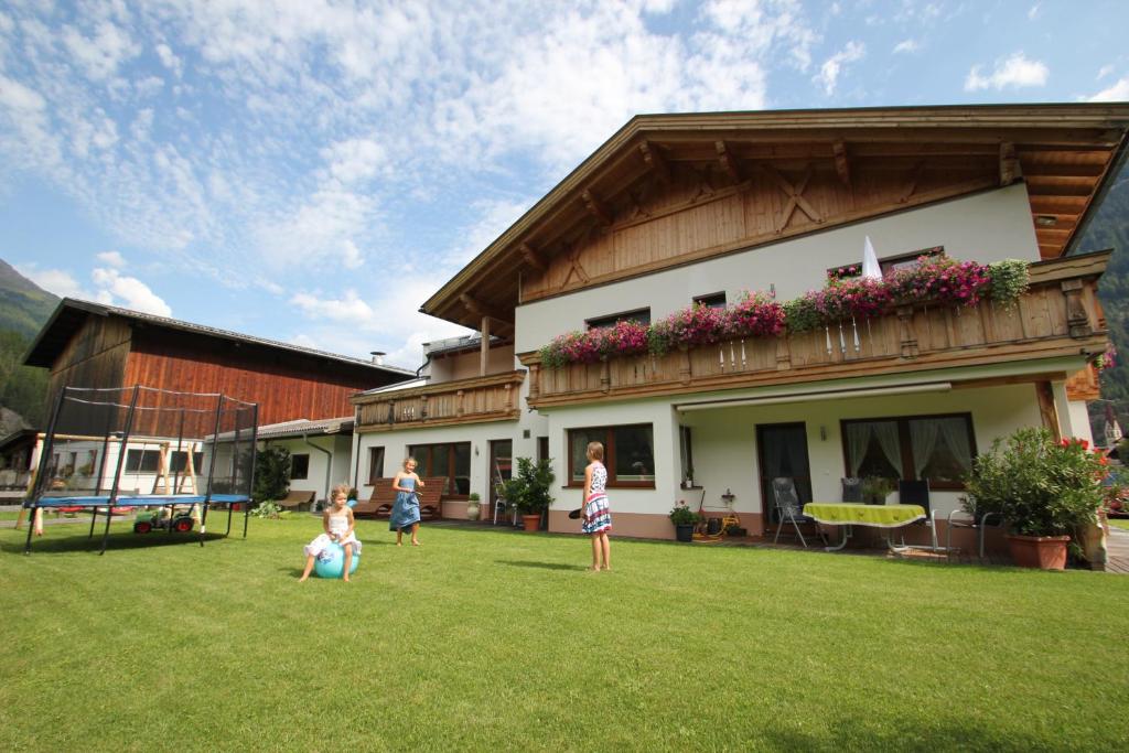 a group of people playing frisbee in a yard at Landhaus Zell in Längenfeld