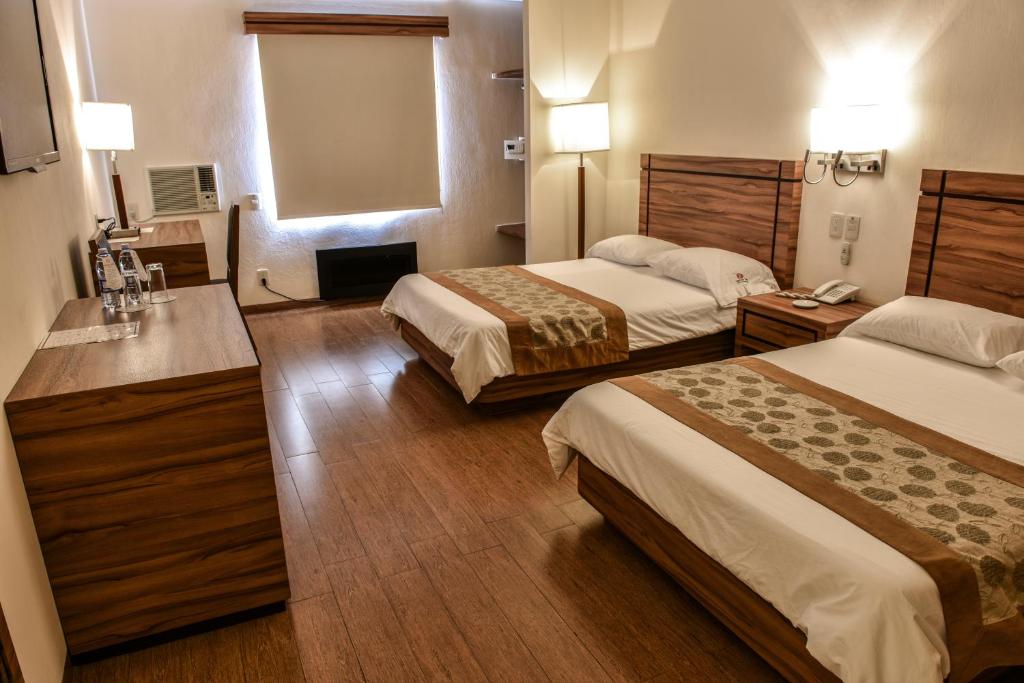 Postel nebo postele na pokoji v ubytování Hotel Oliver Inn - Business Class