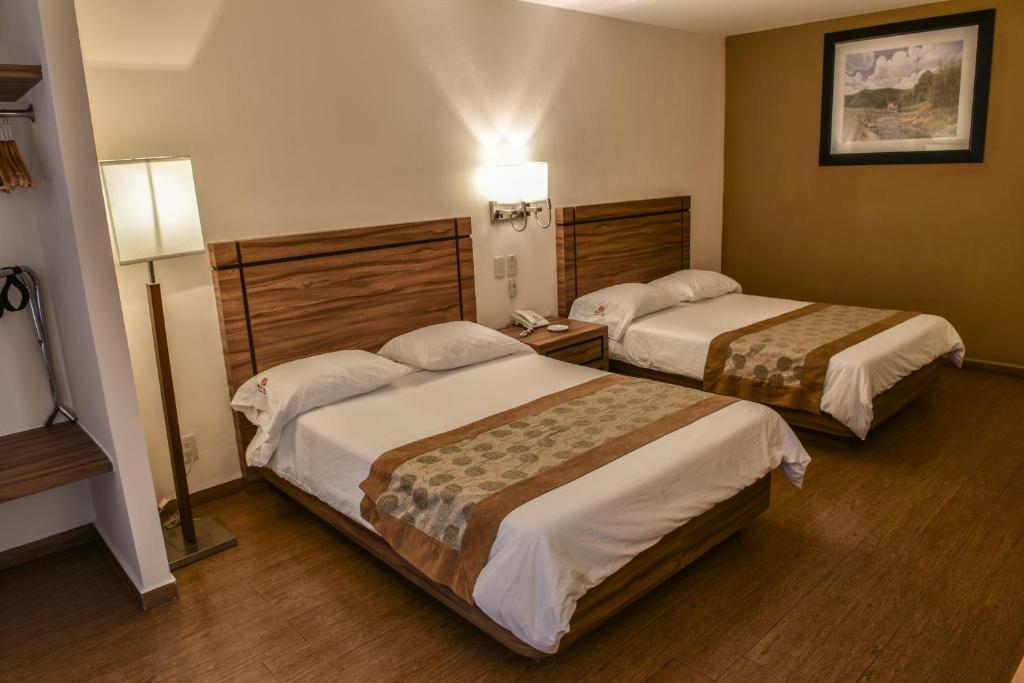 Postel nebo postele na pokoji v ubytování Hotel Oliver Inn - Business Class
