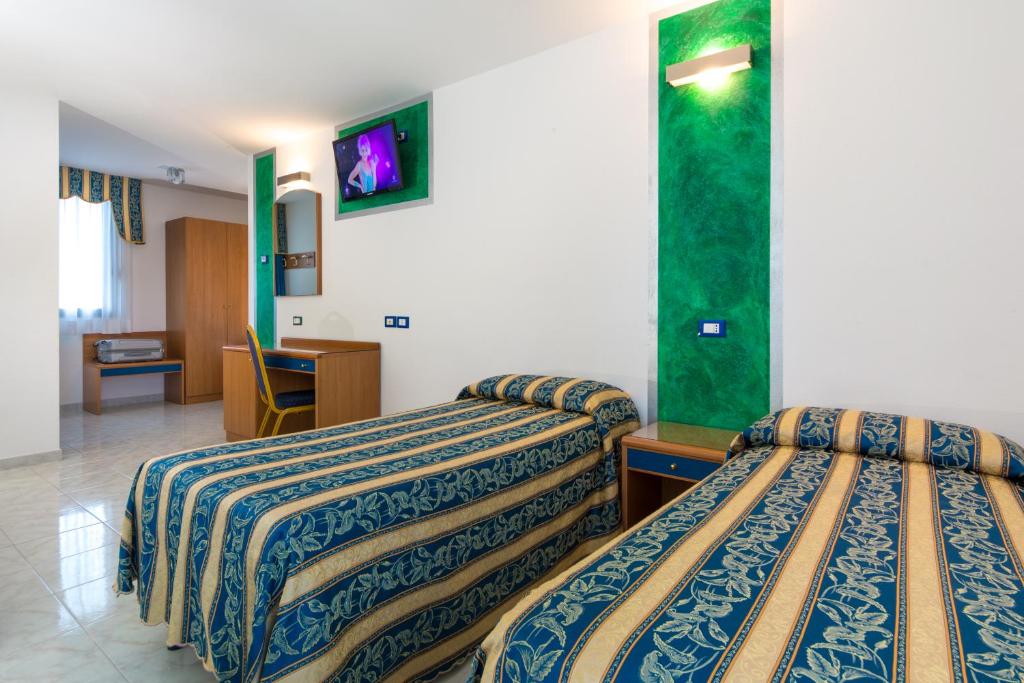 Łóżko lub łóżka w pokoju w obiekcie Hotel Centrale