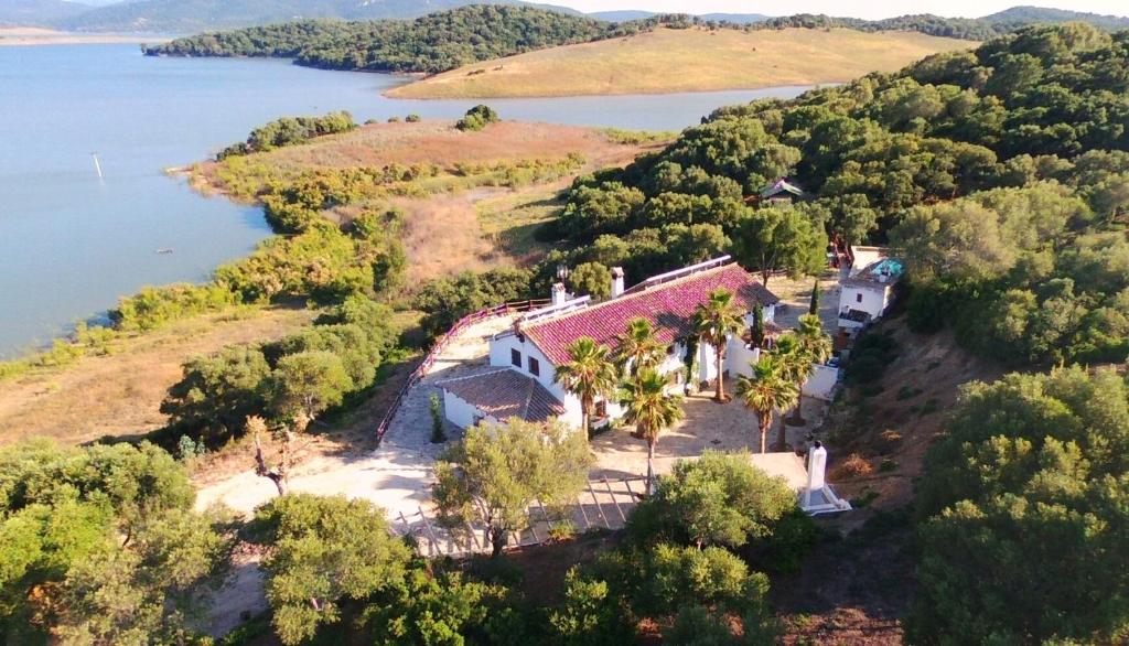 an aerial view of a house on an island in the water at Las Lomillas Reserva Ecológica in Alcalá de los Gazules