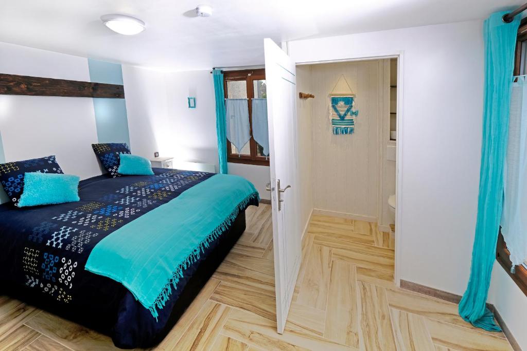 a bedroom with a king sized bed and a door at Le Deroscope in Arrigny