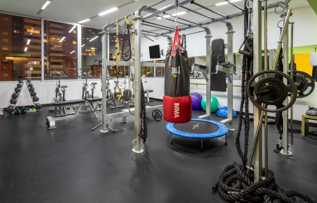 a gym with a bunch of equipment and weights at Biohotel Organic Suites in Bogotá