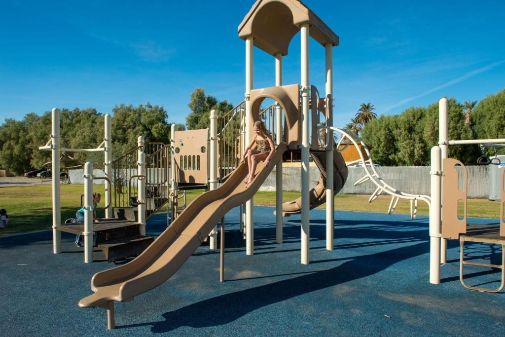 a girl on a slide at a playground at The Ranch At Death Valley in Indian Village