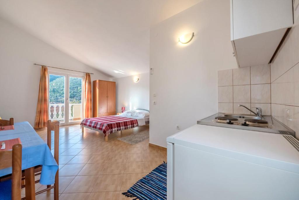 Postel nebo postele na pokoji v ubytování Apartments Slavica