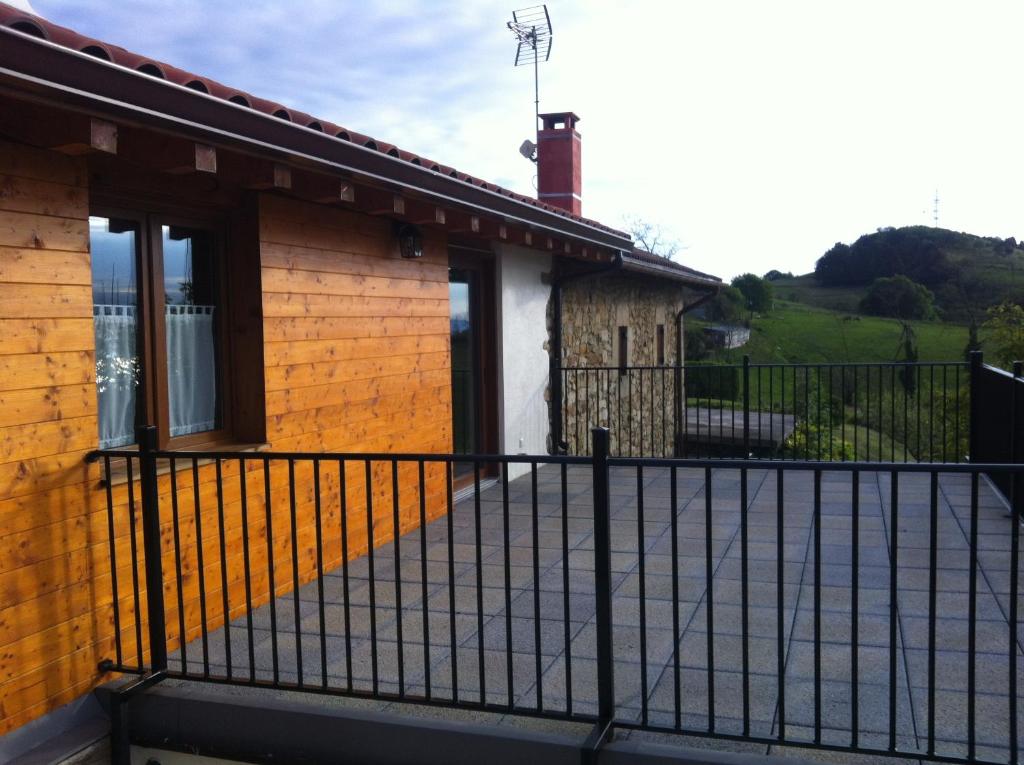a house with a black fence outside of it at Apartamentos Lusarbe in Orio