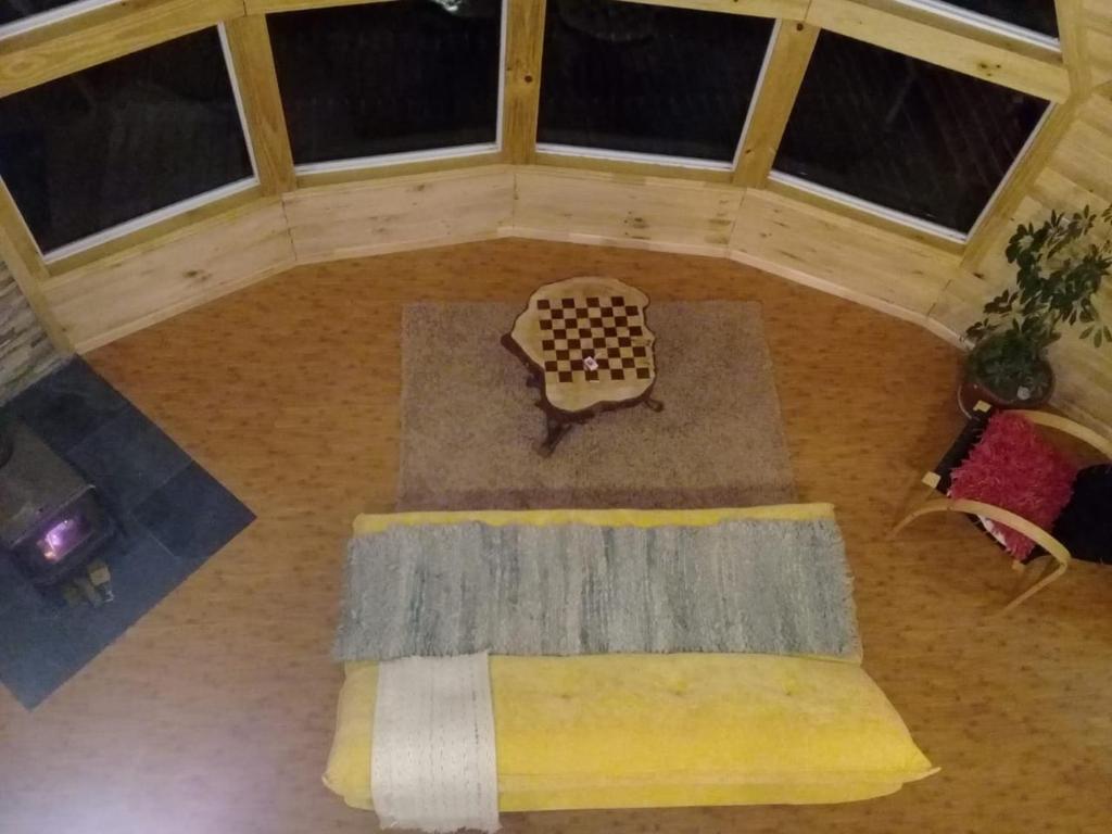 an overhead view of a living room with a checkered floor at domoschiloe in Ancud