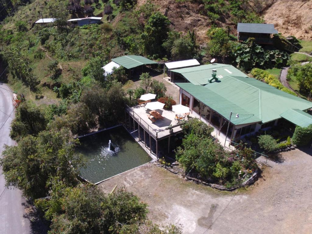 an overhead view of a house with a green roof at Los Lagos Lodge in San Gerardo de Dota