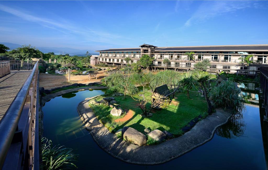 a building with a garden in the middle of a river at Leofoo Resort Guanshi in Guanxi