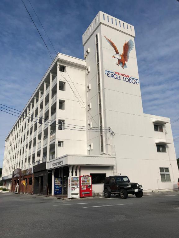 a large white building with a bird on the side of it at Eagle Lodge in Chatan