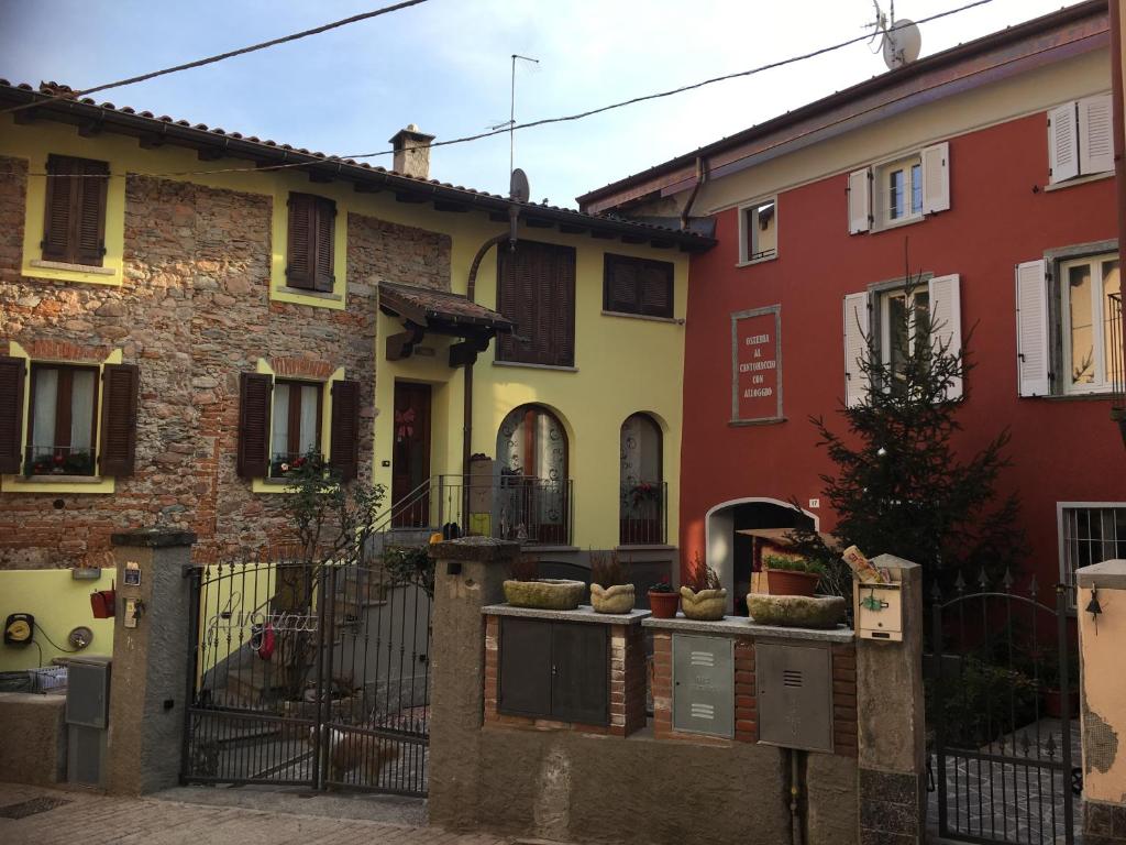 a row of colorful houses in a street at OSTERIA al CANTONACCIO APARTMENTS in Brusimpiano