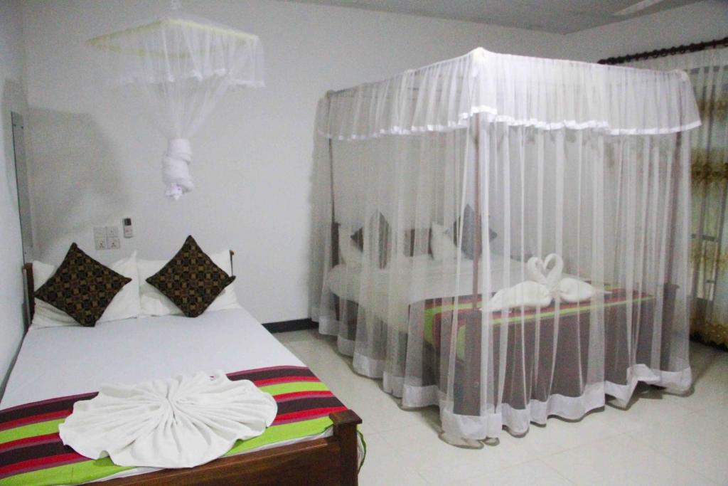 Postel nebo postele na pokoji v ubytování Sigiriya Mana B&B