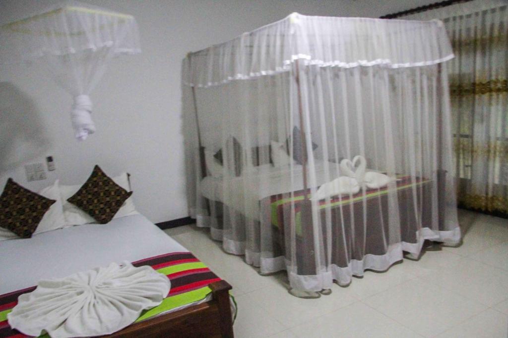 Postel nebo postele na pokoji v ubytování Sigiriya Mana B&B