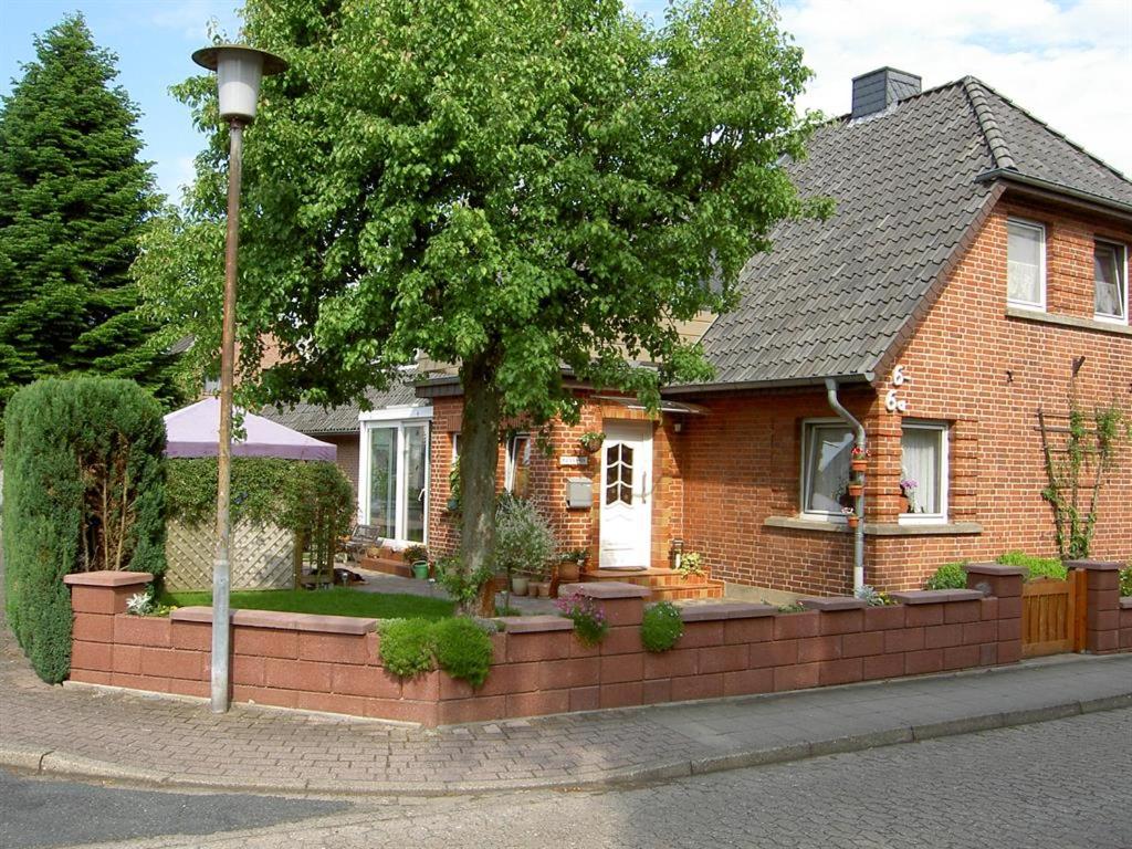 a house with a brick fence in front of it at Mertens in Soltau