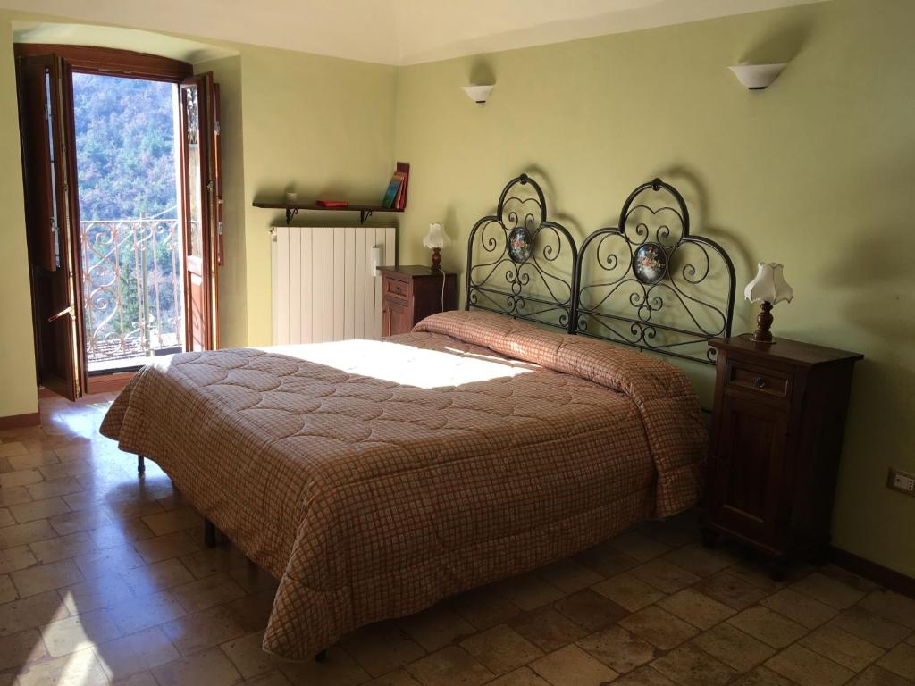 Caporciano的住宿－Regio Tratturo，一间卧室设有一张大床和一个窗户。