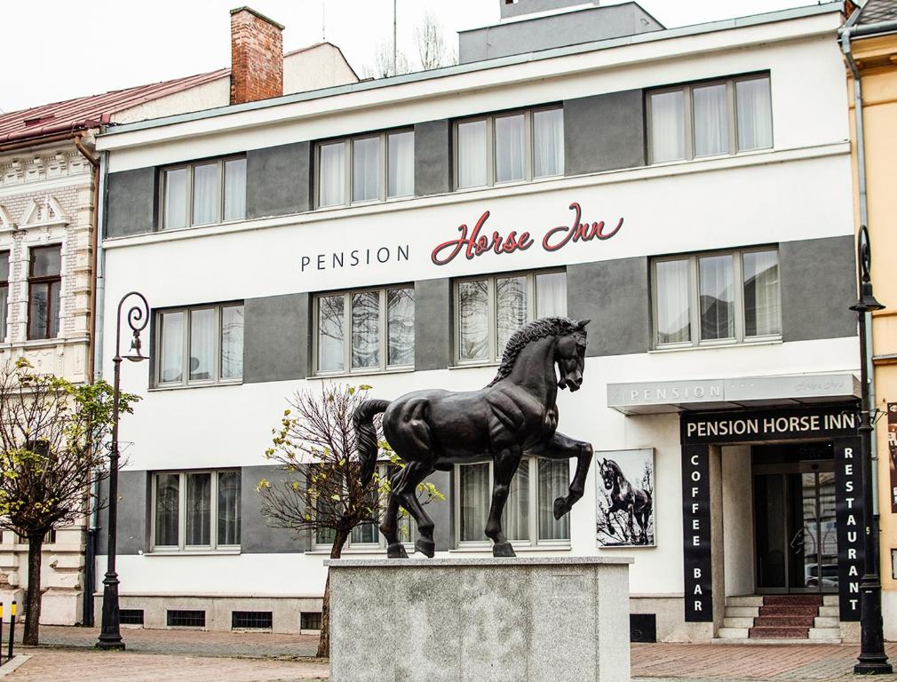 a statue of a horse in front of a building at Pension Horse Inn in Košice