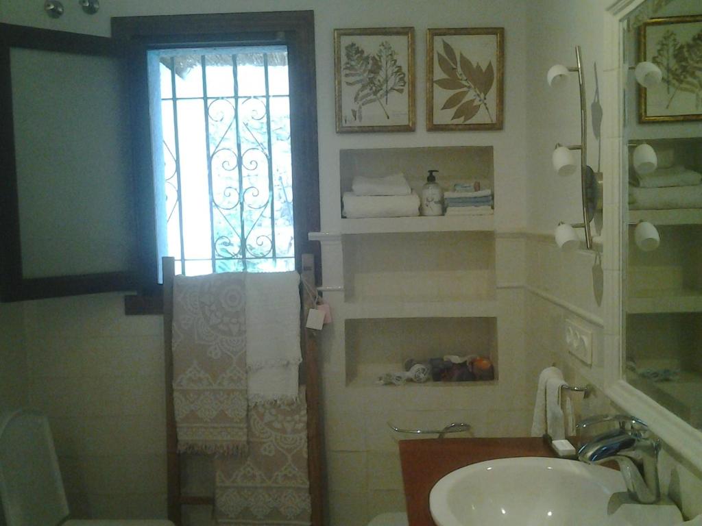 a bathroom with a sink and a window at villaquinta in La Herradura