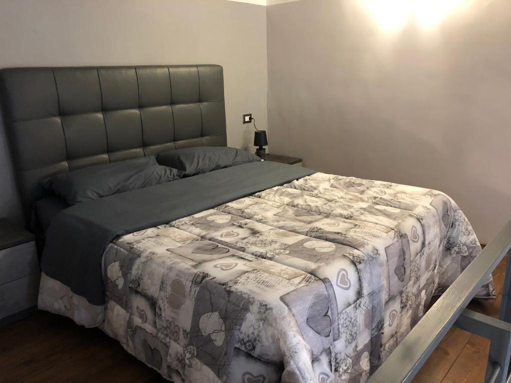 1 dormitorio con 1 cama con edredón en FORIA 58 APARTAMENTS en Nápoles