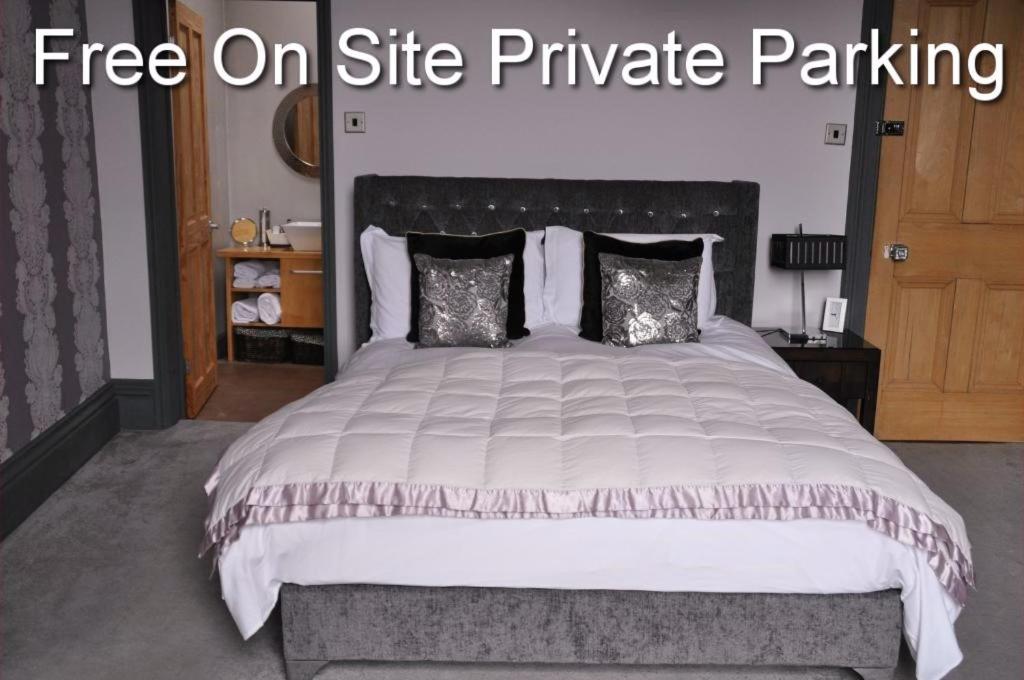 a bedroom with a large bed with a free on site private parking at The Bank Guest House in Hawick