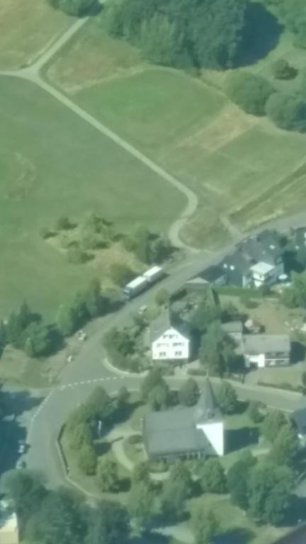 an aerial view of a house in a field at Villa Jani b&amp;b in Breitscheid