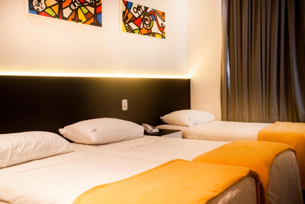 a hotel room with two beds in a room at Bras Palace Hotel in Sao Paulo