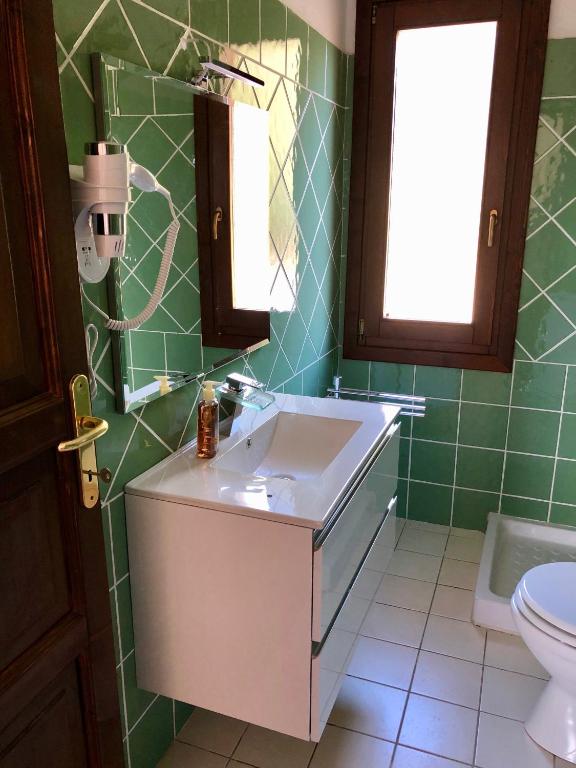 łazienka z umywalką i toaletą w obiekcie Calypso Home Sea View w mieście Badesi