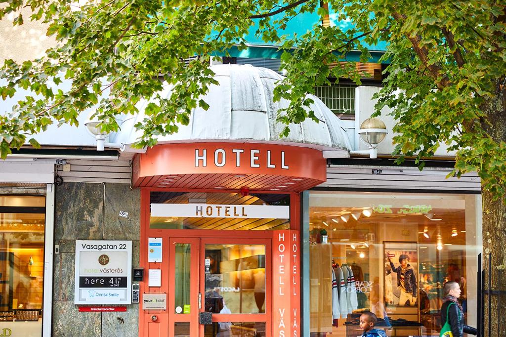 a hotel sign in front of a store at Hotell Västerås in Västerås