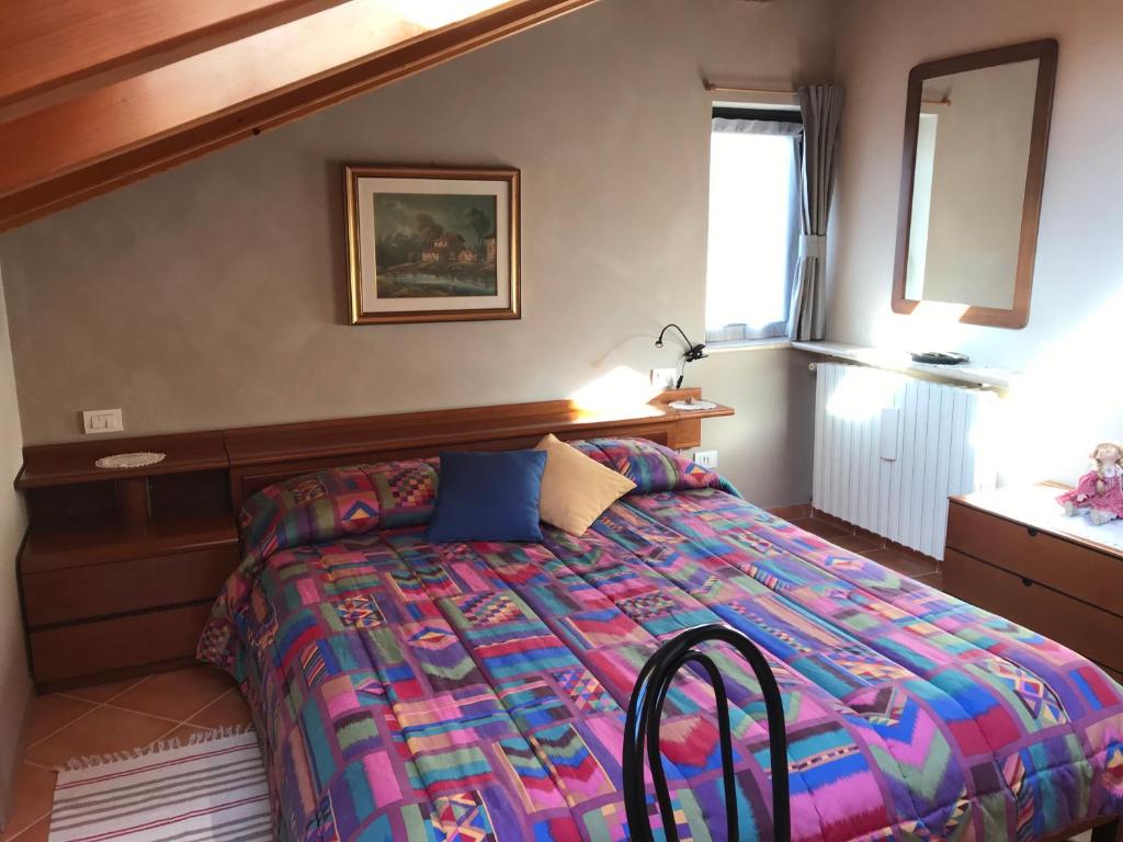 A bed or beds in a room at Mansarda Margherita