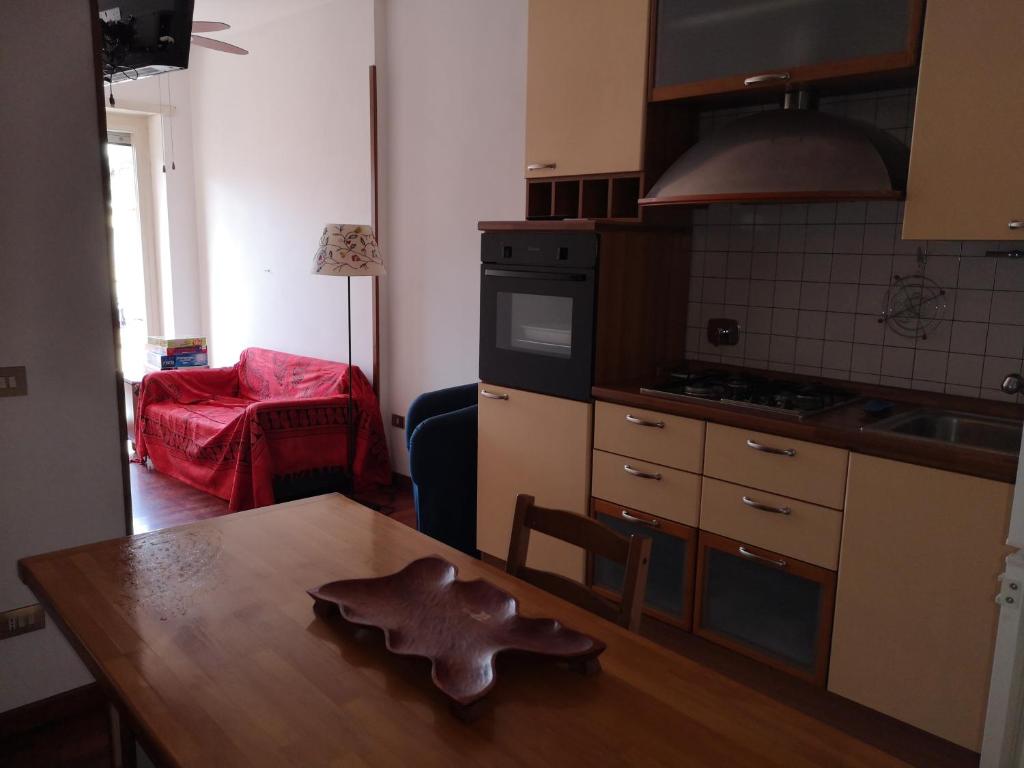 a kitchen with a wooden table in a room at Checchi House in Rome