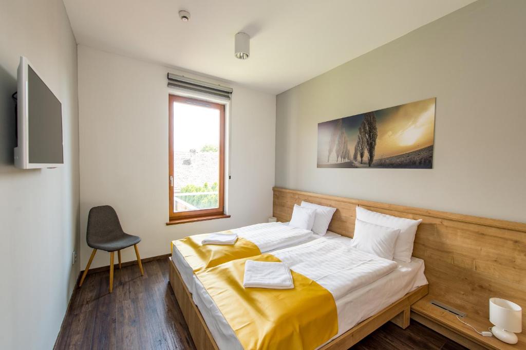 Postel nebo postele na pokoji v ubytování Pilvax Hotel Kalocsa