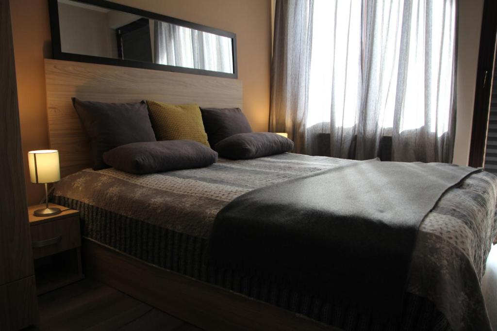 a bed with two pillows on it in a bedroom at Apartment 46 in Sofia