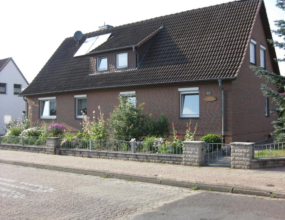 a red brick house with a black roof at Gollnow in Soltau
