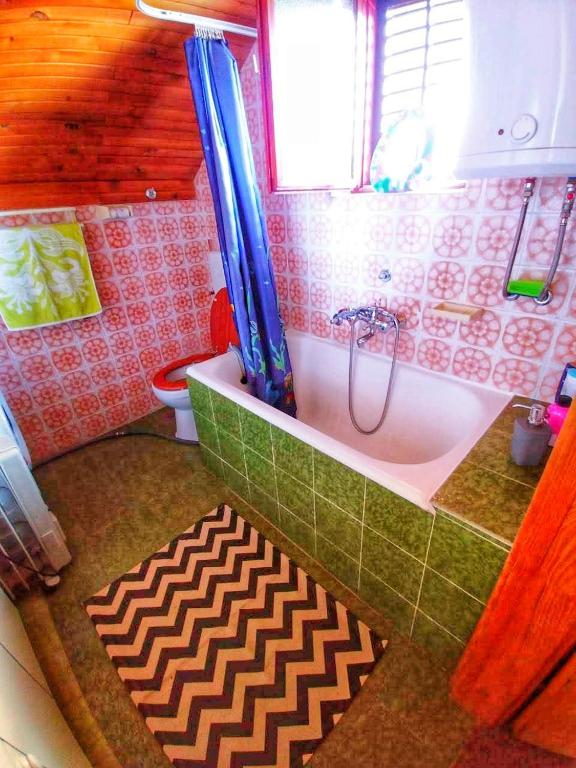 a bathroom with a tub and a toilet and a sink at Kuća za odmor &quot;Livadica&quot; in Netretić