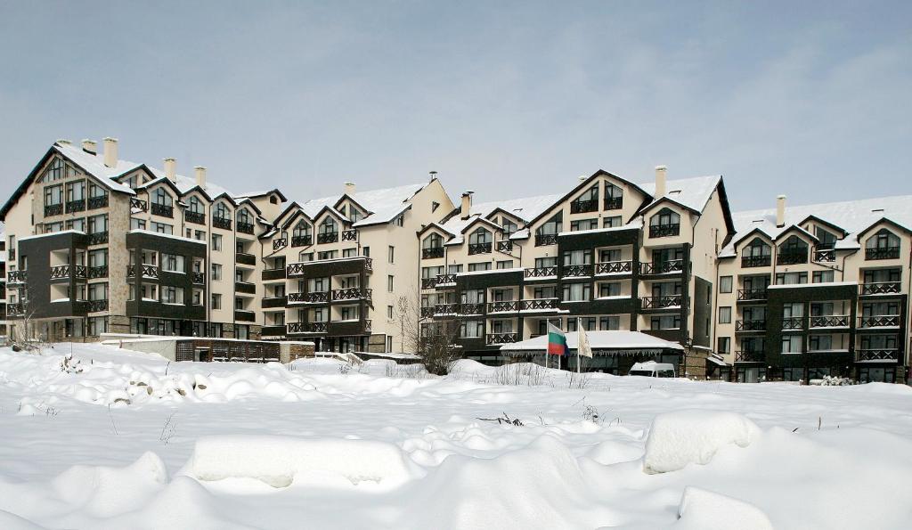 a group of apartment buildings in the snow at Premier Luxury Mountain Resort in Bansko