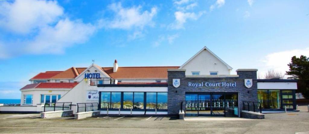 a building with a sign for a road court hotel at Royal Court Hotel in Portrush