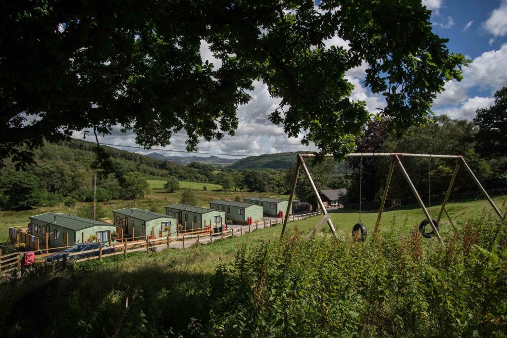 a train yard with houses in a field at Parkgate Farm in Holmrook