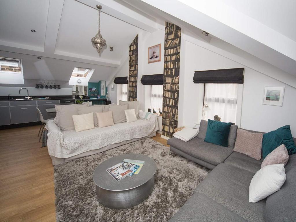 a living room with a couch and a table at Regent Penthouse in Harrogate