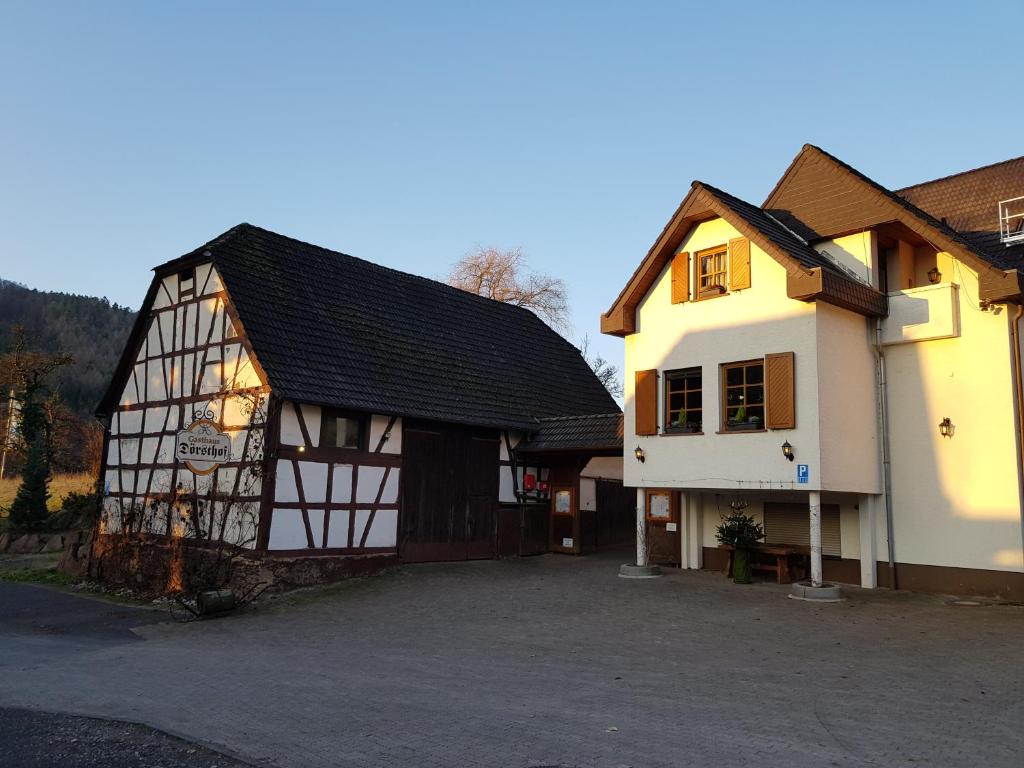 a black and white building with a garage at Gasthaus Dörsthof in Alzenau in Unterfranken