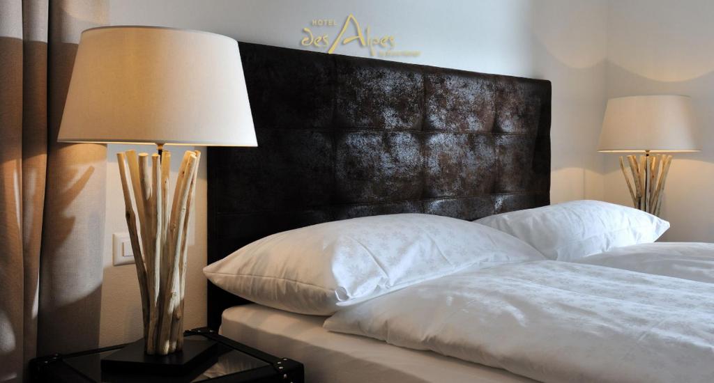Postel nebo postele na pokoji v ubytování Hotel des Alpes Superieur