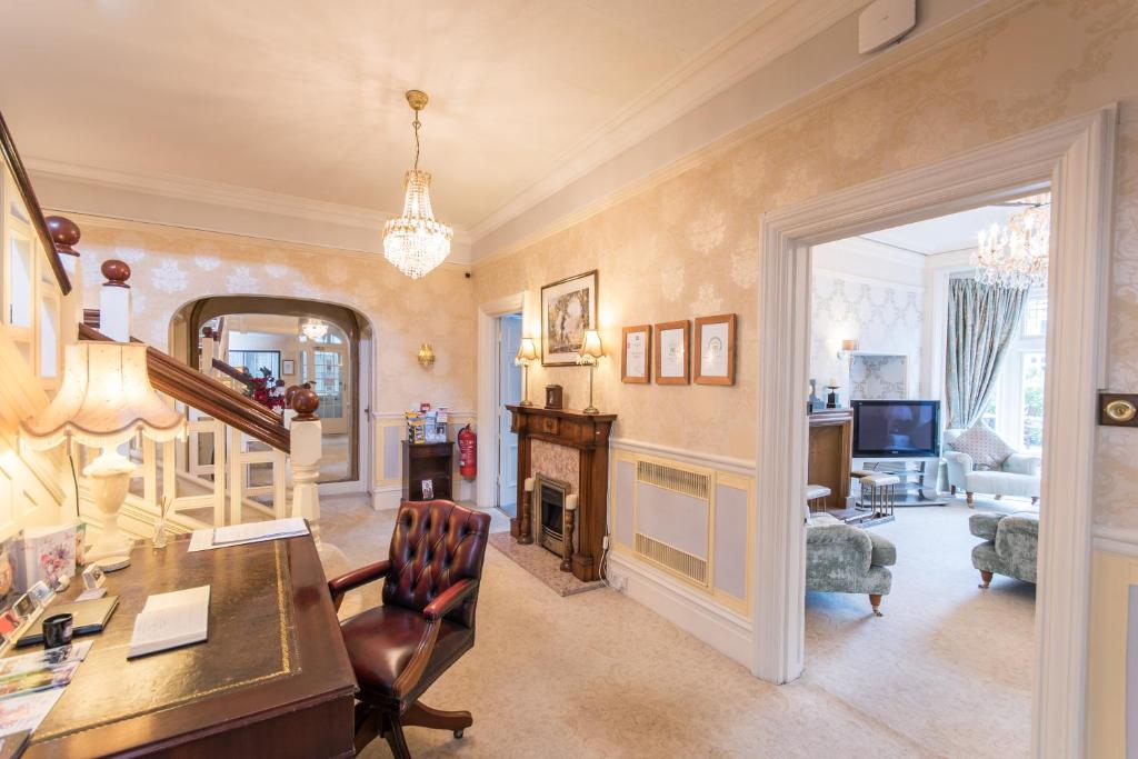 a home office with a desk and a chair at Grovefield Manor in Poole