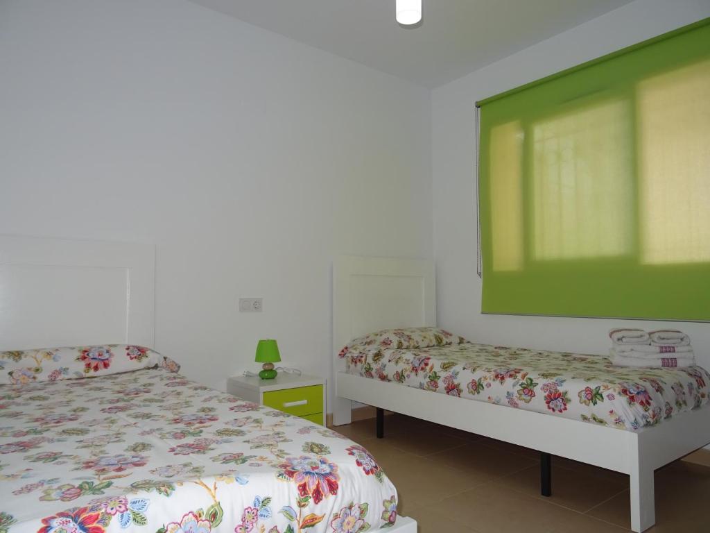 A bed or beds in a room at Apartamento Azul Beach La Mata Playa