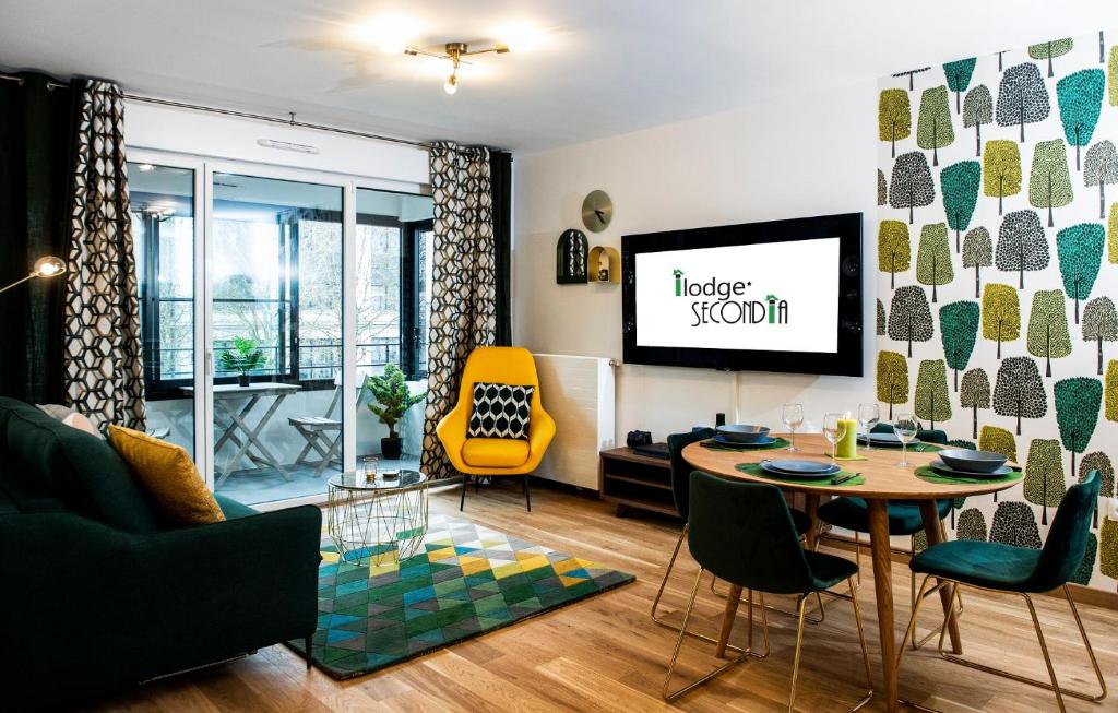 a living room with a table and a yellow chair at ILodge Secondia in Chessy